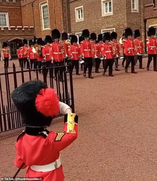 Frank waited outside of St James' Palace, London, dressed in a red tunic and bearskin to salute the guards