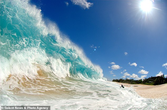 Dies ist eine gigantische, acht Fuß hohe Welle auf Hawaii, aus der sich ein einsamer Surfer zurückzieht.  Die Welle, die Owen Wright versenkte, war 15 Fuß hoch