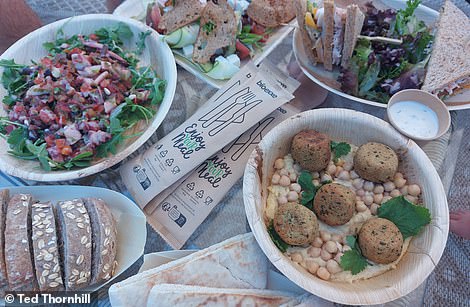 Taste buds are tickled at a little picnic spot with parasols next to the beach, where superb lunches (above) are served up from a cute little blue kitchen trailer