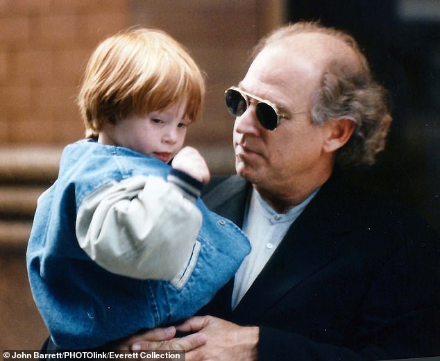 Jimmy Buffett and son Cameron are seen in 1996. The singer on Friday 'passed away peacefully surrounded by family, friends, music and dogs'