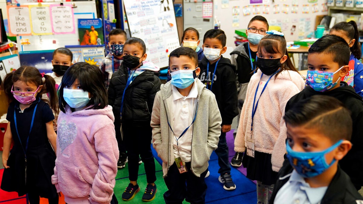 DATEI: Kindergärtner tragen Masken, während sie ihrer Lehrerin inmitten der COVID-19-Pandemie an der Washington Elementary School am 12. Januar 2022 in Lynwood, Kalifornien, zuhören.