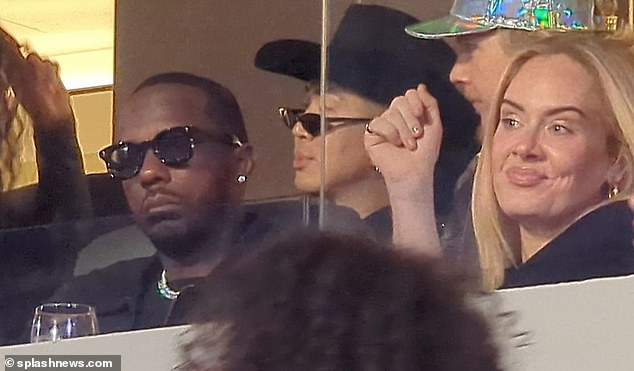 Adele smiles next to her boyfriend Rich Paul while watching the gig at SoFi Stadium last night