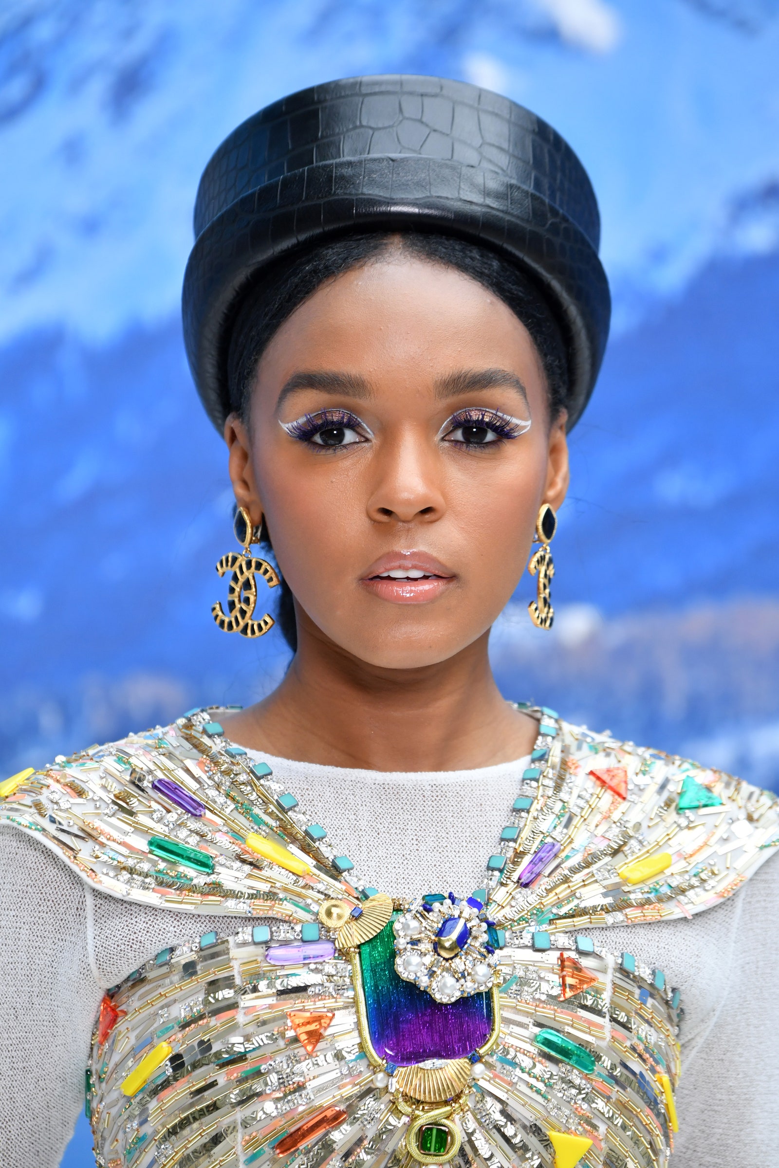 Janelle Monae in a black hat with white negative space eyeliner '70s makeup trend