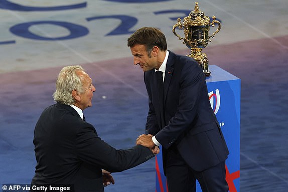 French President Emmanuel Macron greets World Rugby Chairman Bill Beaumont (L) during the opening ceremony of the France 2023 Rugby World Cup ahead of the Pool A match between France and New Zealand at the Stade de France in Saint-Denis, on the outskirts of Paris on September 8, 2023. (Photo by Thomas SAMSON / AFP) (Photo by THOMAS SAMSON/AFP via Getty Images)