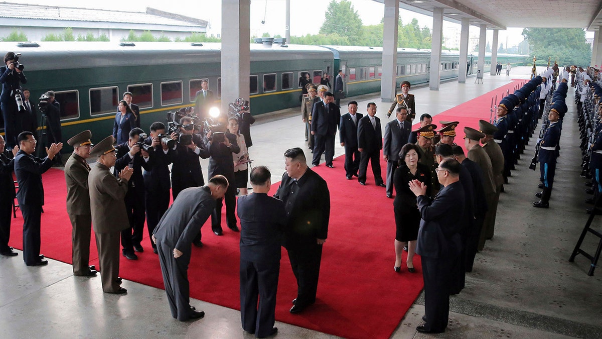 Kim, andere Beamte an einem Bahnhof