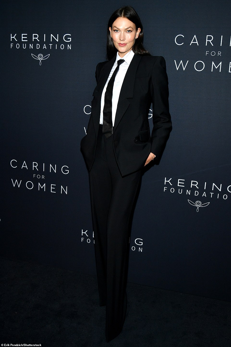 Dapper: Karlie Kloss cut a dapper figure as she posed up for shutterbugs in a fitted black suit and tie