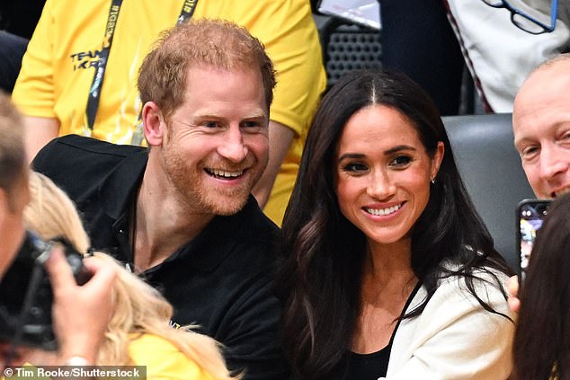 Prince Harry and Meghan Markle pose for a selfie at the wheelchair basketball match today