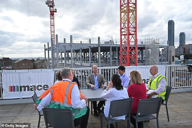 Up on the roof: At the start of the day, the Prince headed high up for a meeting with workers from across the construction industry