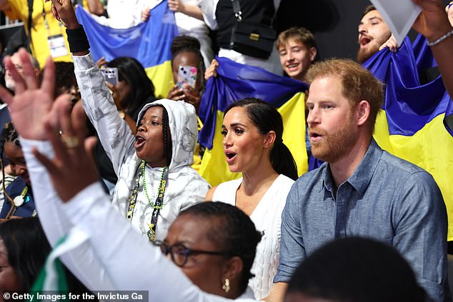 The couple were seen cheering on the teams as they stood with crowds watching the Ukraine vs Nigeria match