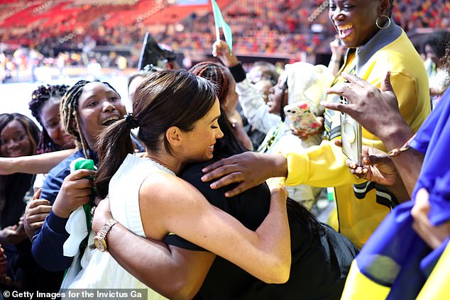 Meghan hugs a Nigerian support at the preliminary round of the mixed volleyball games