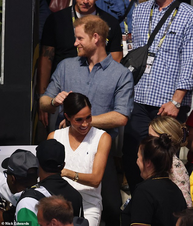 As he starts dancing, Meghan continues to chat with adoring fans
