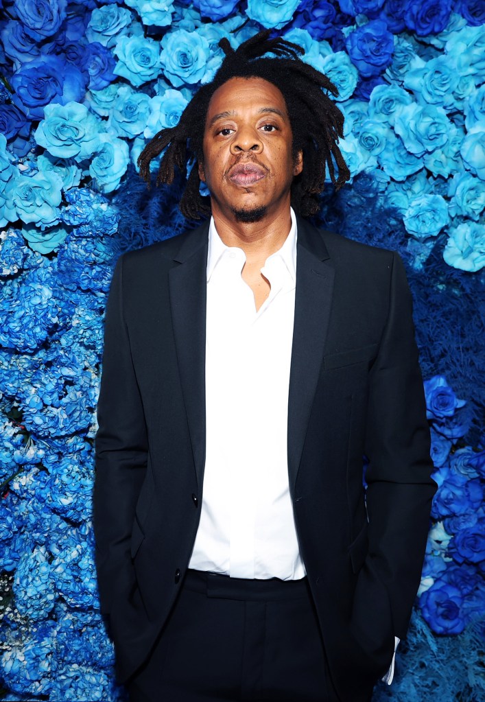 Jay Z vor blauen Blumen. 