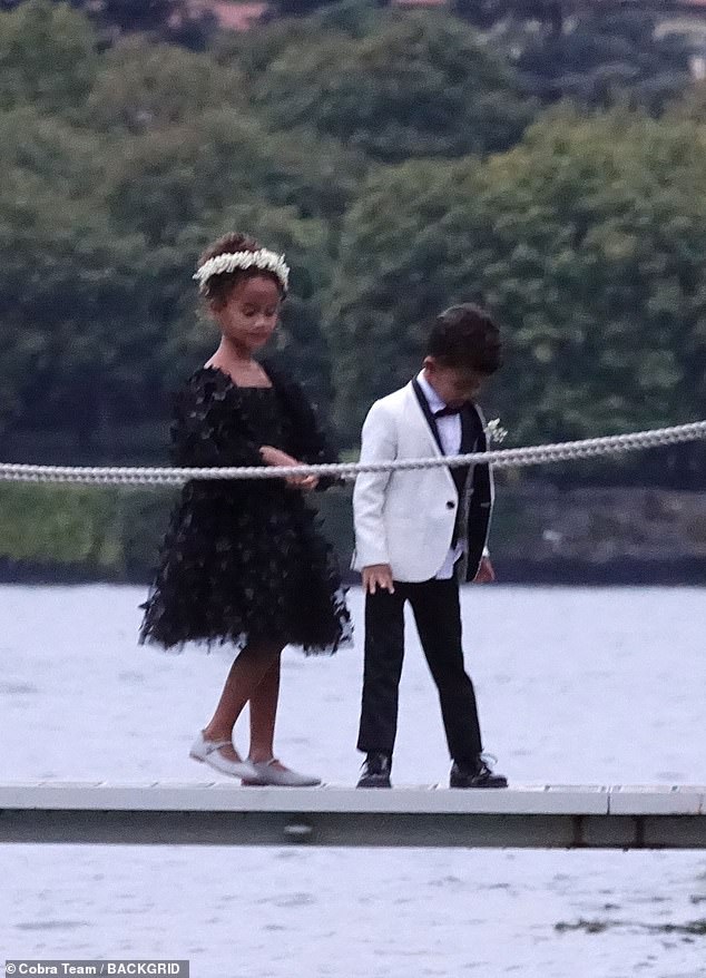 Kids: The couple's daughter Luna, seven, looked adorable in a knee-length, textured black dress. Their eldest child had her hair in an updo and wore a white flower crown. Their son Miles, five, wore a miniature version of his father's tuxedo