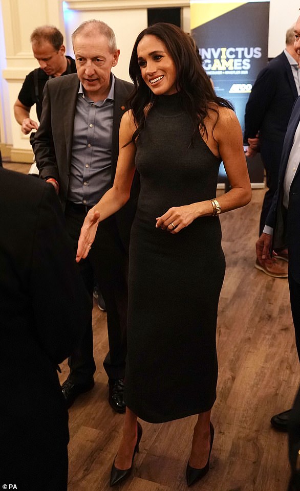 Later, she changed into a sleek black dress as she met a delegation for the 2025 Invictus Games in Canada. Meghan wore a £390 High-Neck Ribbed Wool-Blend Midi Dress in Grey from Toteme which she paired with £500 Dioressence 100¿ Black Leather Pumps