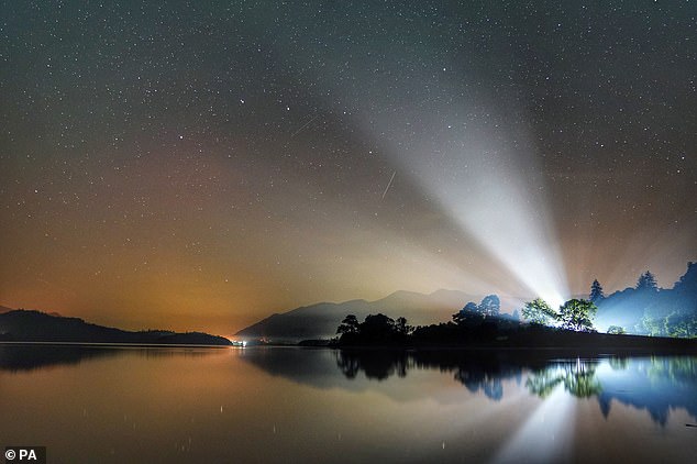 A faint glow from the northern lights (aurora borealis) over Derwentwater looking towards Skiddaw mountain in the Lake District, Cumbria, during the early hours of September 8, 2021