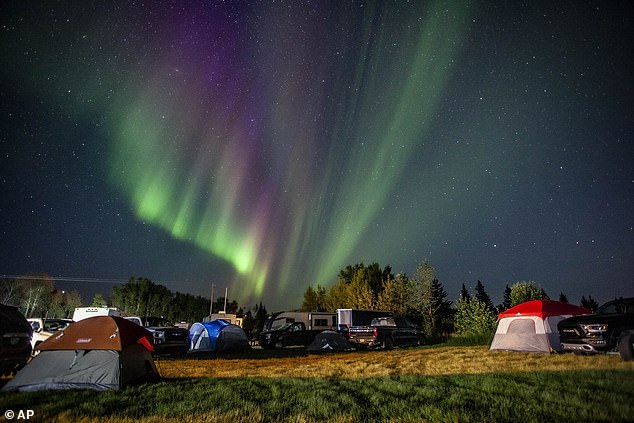 Evacuees from Yellowknife, Canada, are met by the aurora borealis as they arrive to a free campsite in High Level, Alberta, August 18, 2023