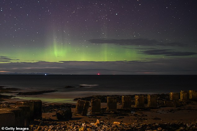 Aurora borealis is seen above WW2 beach defenses on February 20, 2021 in Lossiemouth, Scotland