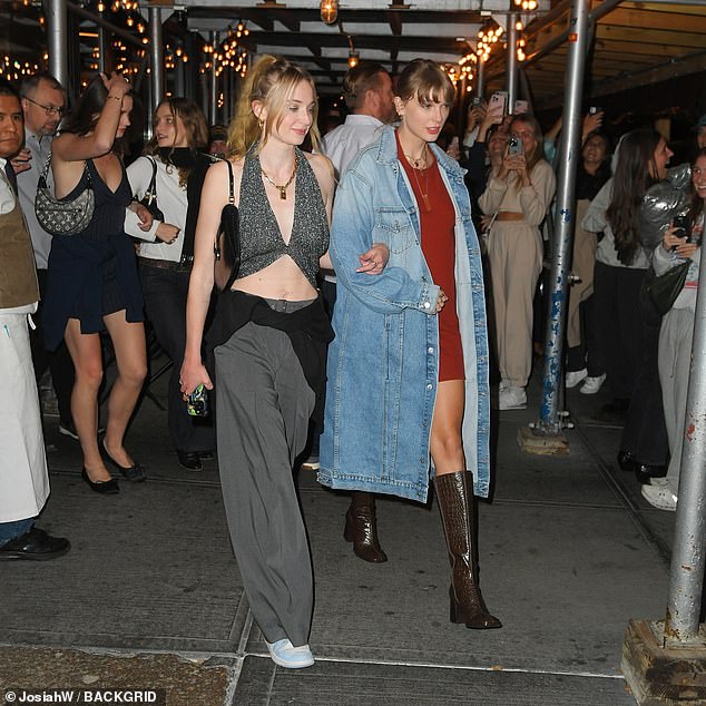 Night on the town: She slipped into a pair of brown, crocodile-embossed boots that contained a chunky heel on the back