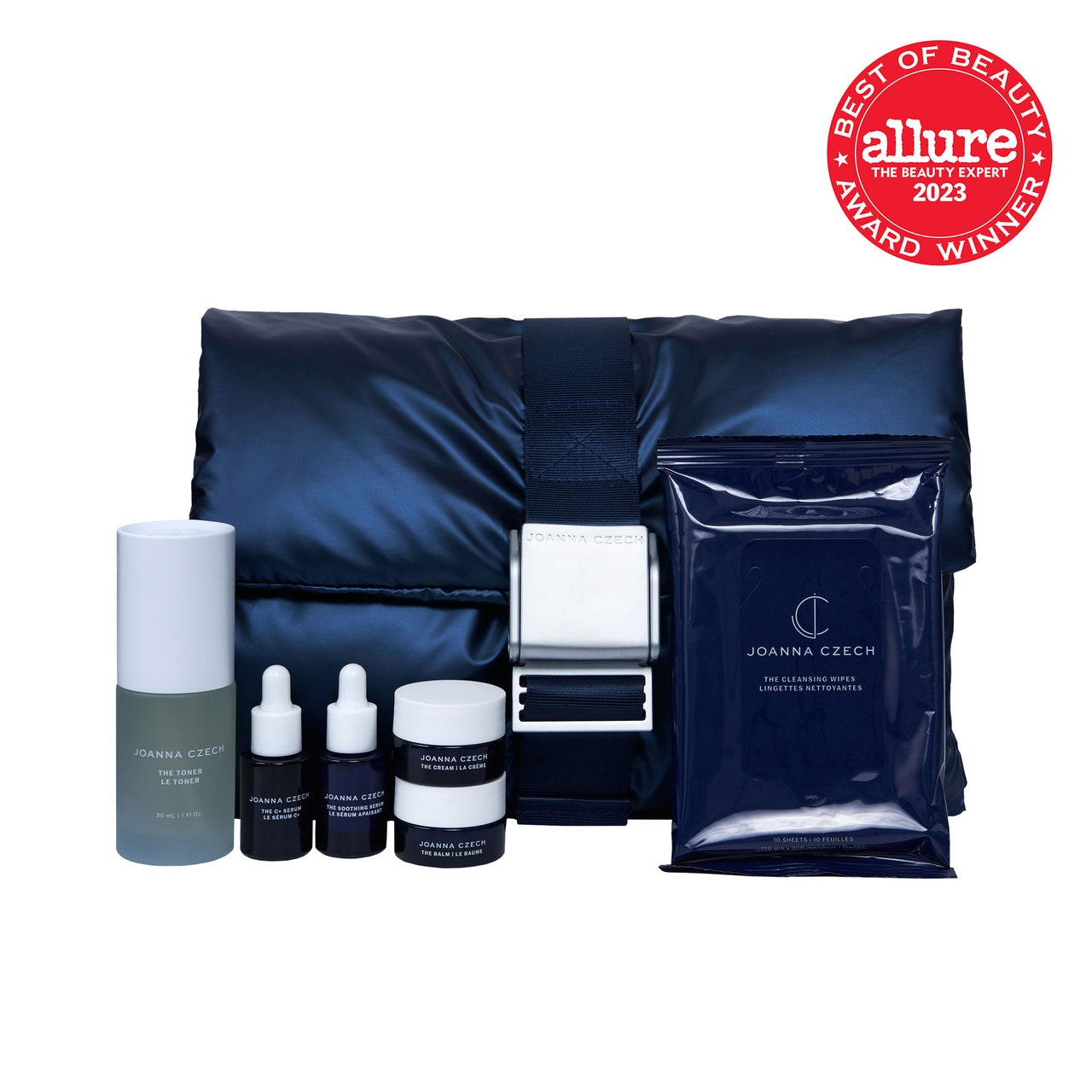 Joanna Czech Skincare The Minis Edit mini navy bottles of skincare products with white caps, navy face mask sachets, and navy pillow on white background with red Allure BoB seal in the top right corner