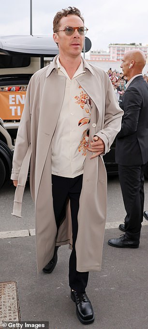 Stylish: Benedict's floral patterned shirt and sweeping cream Prada coat ensured he claimed his own share of the spotlight