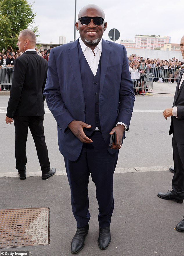 Stepping out: Outgoing British Vogue editor-in-chief Edward Enninful greeted onlookers with a  smile after arriving for the exclusive presentation