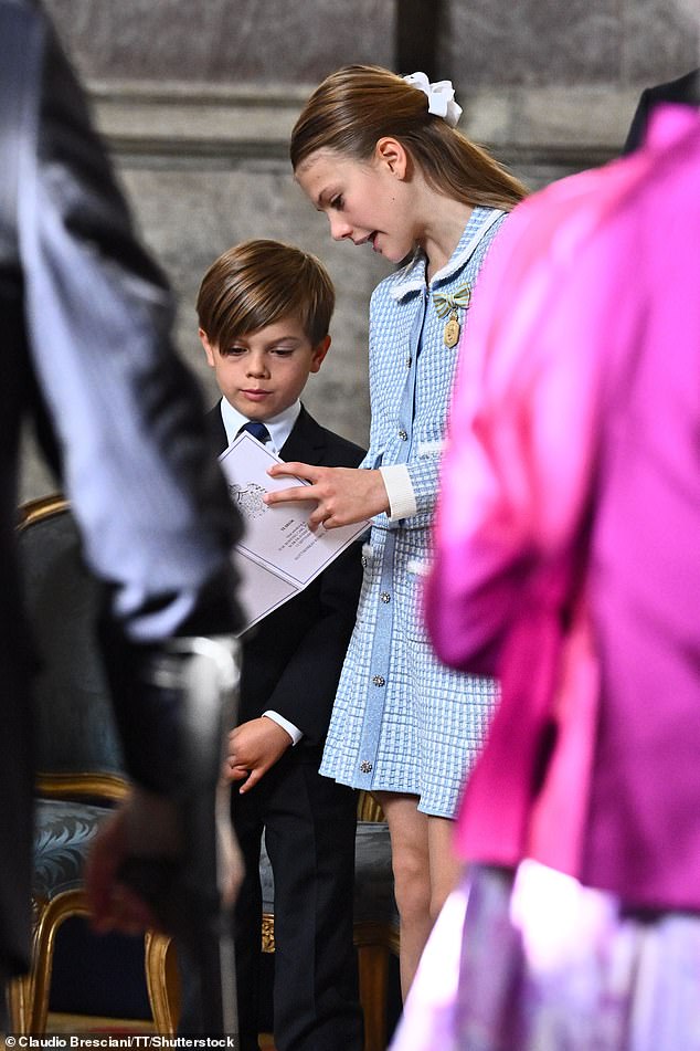 Sweden's royal siblings, Estelle and Oscar share a conversation before they are seated for the thanksgiving service in Palace Church at the Royal Palace in Stockholm