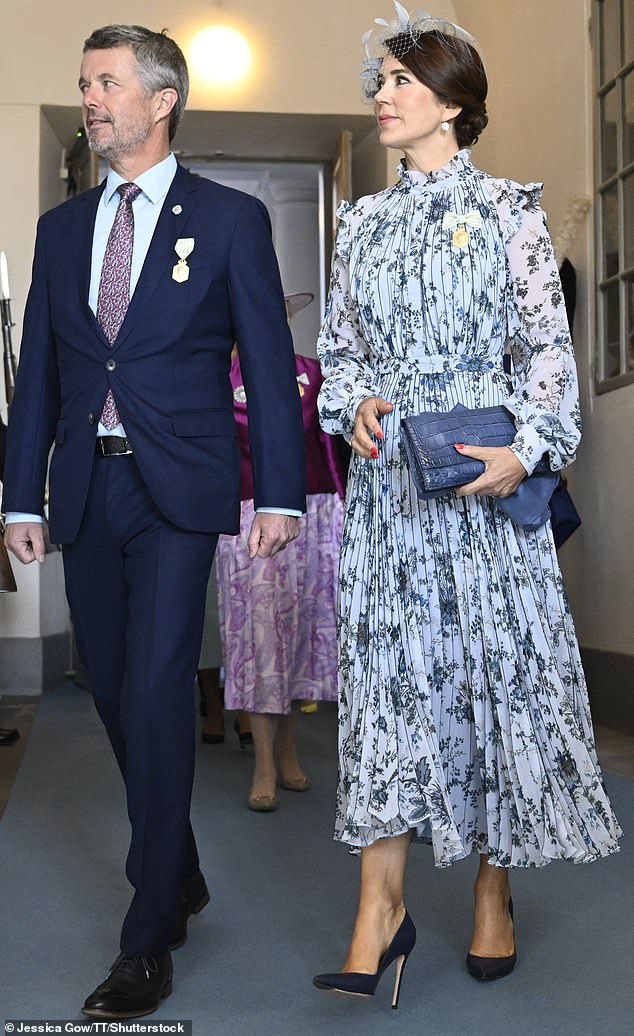 Denmark's Crown Prince Frederik (left) and Crown Princess Mary (right) coordinated their outfits for the event with the colour purple