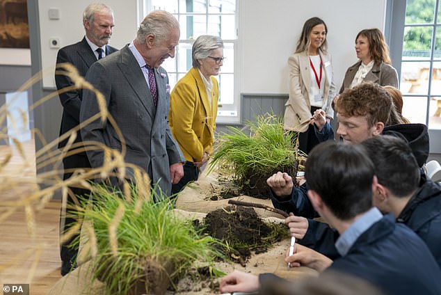 King Charles III meets students carrying out root and soil structure analysis during a visit to officially open the MacRobert Farming and Rural Skills Centre at Dumfries House