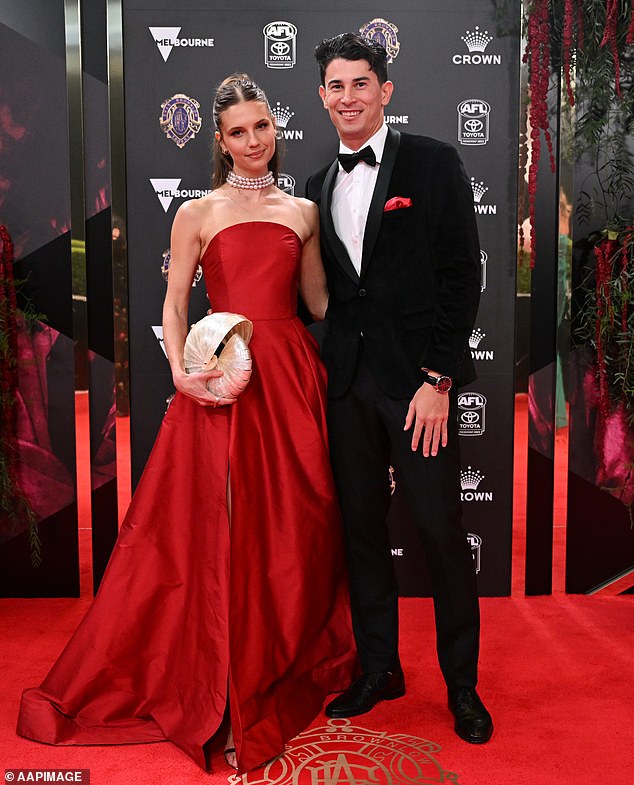 Fremantle player Bailey Banfield had Julia Edwards on his arm, with the AFL star opting for a black tuxedo with a red pocket square to match his date's dress
