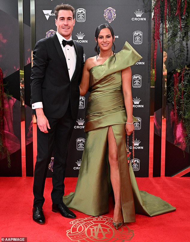 Jeremy Cameron chose a neat black tux while the Geelong player's partner Indiana Putra wore an olive green frock with a dramatic shoulder details