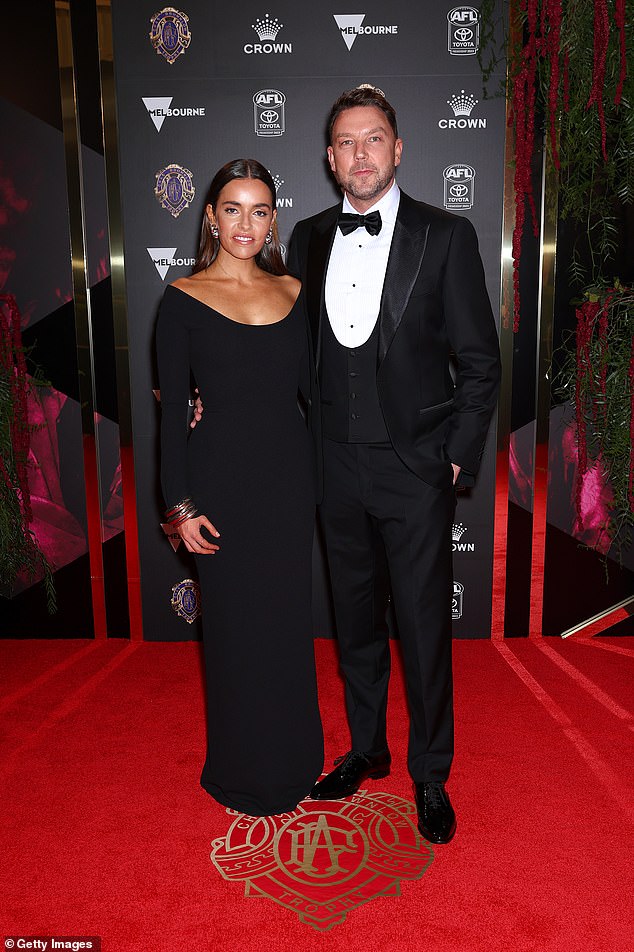 AFL Head Of Corporate Affairs Jay Allen looked smart in his fitted suit while his partner chose a simply chic flowing black gown