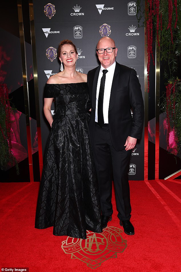 AFL Executive General Manager Brian Walsh enjoyed a date night with Julia Edwards who looked glamorous in a pretty off-the-shoulder black frock