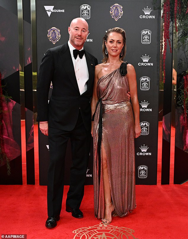 Carlton Football Club President Luke Sayers had his wife Cate Sayer on his arm, with Cate shimmering in a slinky bronze frock