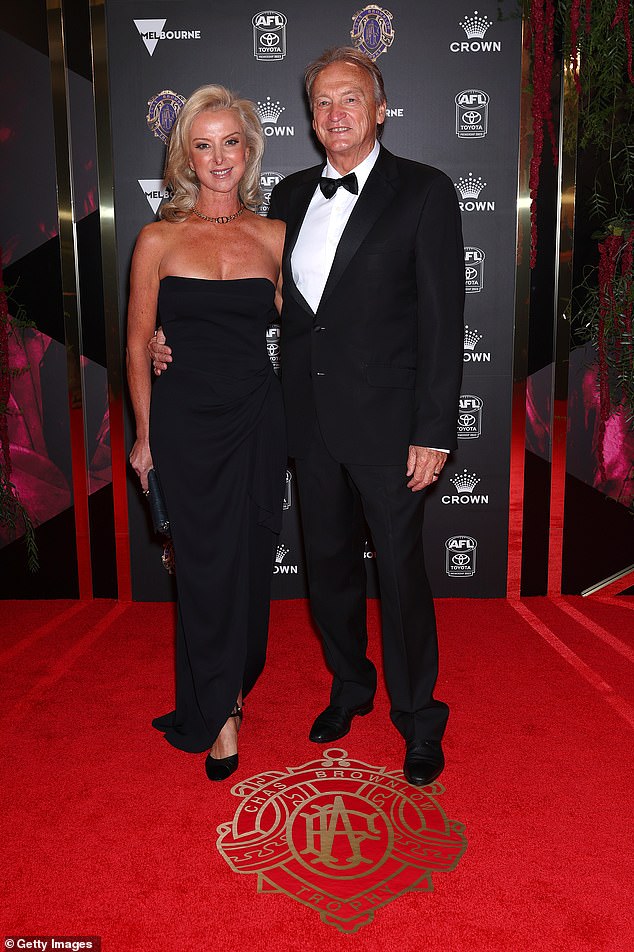 CEO of Carlton FC Brian Cook and partner Clare Schultze posed arm in arm, with Clare stunning in a black, strapless dress that clung to her incredible figure