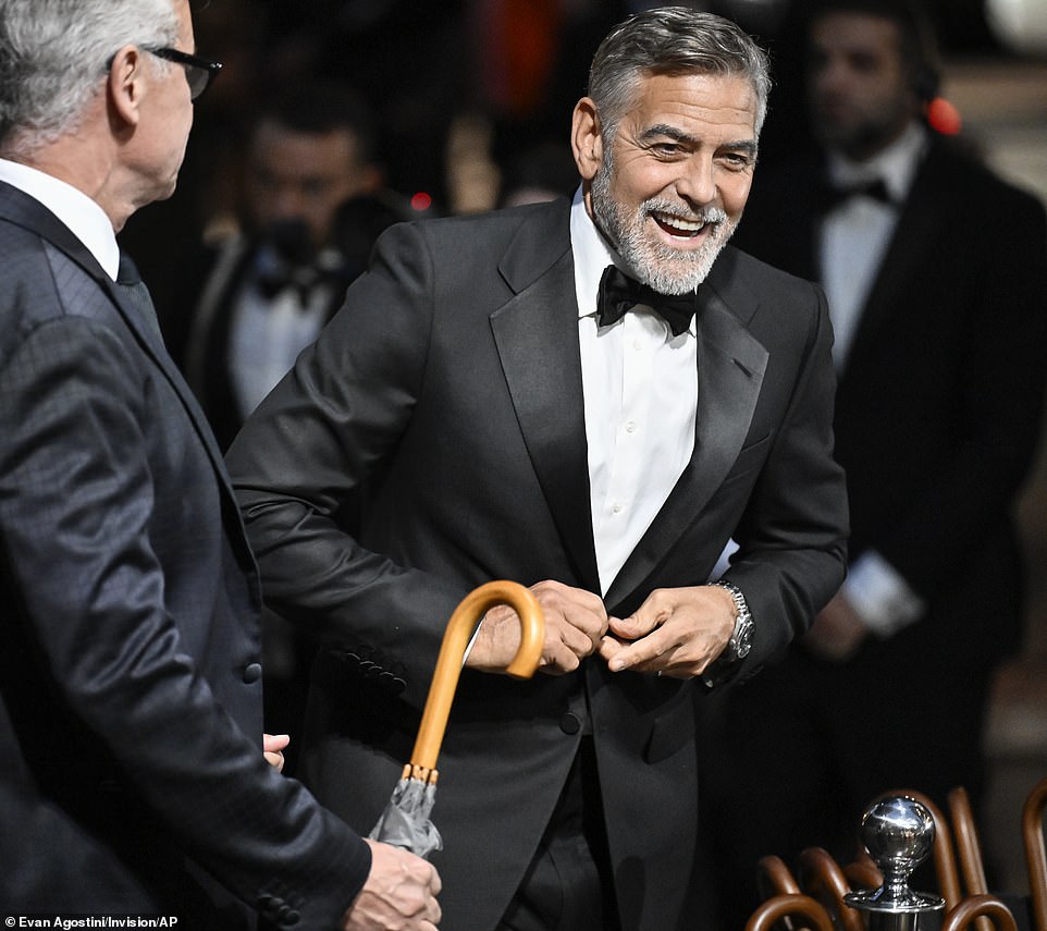 Meanwhile: George, plumping for the silver fox look with a white beard and distinguished salt-and-pepper hairdo, modeled his signature classic tuxedo as he posed on his wife's arm