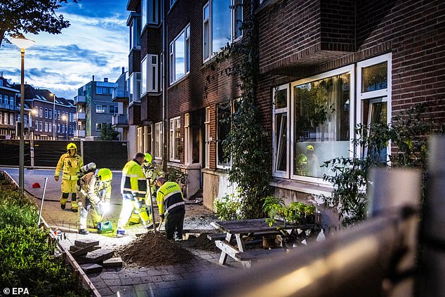 Suspected gunman Fouad L, 32, burst into the family's home in the city on Thursday and sprayed bullets at his 39-year-old neighbour, named locally as Marlous, and her 14-year-old daughter, killing them both. Pictured: Police and fire brigade work at the scene on Thursday night