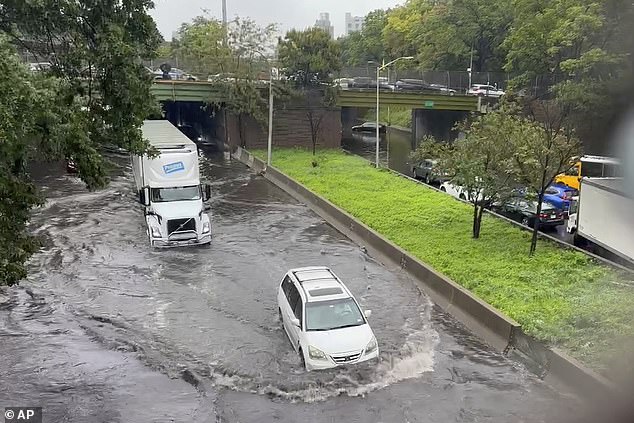 New York City has declared a state of emergency as the city prepares to be dumped with up to seven inches of rain on Friday. Traffic makes its way through flood waters along the Brooklyn Queens Expressway on Friday