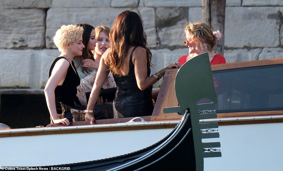 Exciting: A hoard of female guests were seen arriving by boat ahead of the wedding service, among them Julia Garner (far left)
