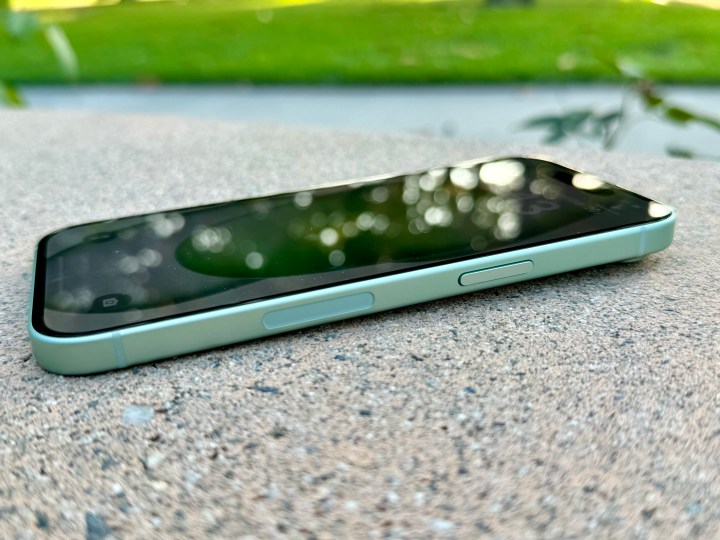 Side view of a green iPhone 15 showing the side button.