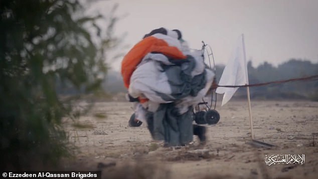 A Hamas fighter holding a parachute during the rehearsal