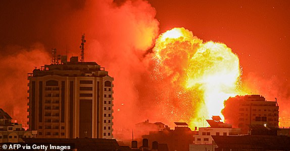 A fireball erupts from an Israeli airstrike in Gaza City on October 9, 2023. The death toll from the unprecedented assault by Palestinian militant group Hamas on its territory rose to 900 in Israel, which has retaliated with a withering barrage of strikes on Gaza, raising the death toll there to 687. (Photo by MAHMUD HAMS / AFP) (Photo by MAHMUD HAMS/AFP via Getty Images)
