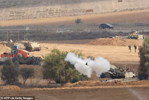 Israeli soldiers fire artillery cannon towards Gaza Strip from the Israel-Gaza border on October 11, 2023