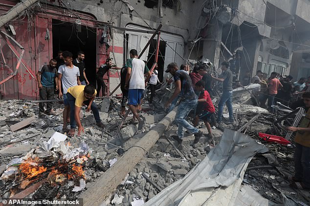 Palestinians are seen picking through the rubble in Gaza after Israeli airstrikes