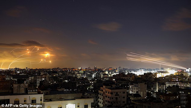 Rockets fired from the Gaza City (R) being intercepted by Israel's Iron Dome defense missile system (L) on Tuesday