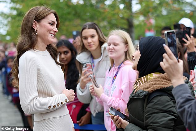 The Princess smiled as she chatted to a young woman who had queued up in chilly weather to meet her