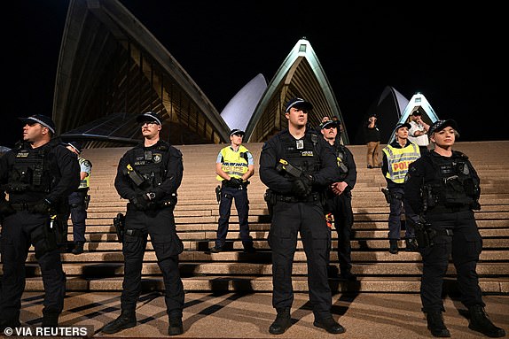 Police look on during a pro-Palestinian rally outside the Sydney Opera House in Sydney, October 9, 2023. AAP Image/Dean Lewins via REUTERS  ATTENTION EDITORS - THIS IMAGE WAS PROVIDED BY A THIRD PARTY. NO RESALES. NO ARCHIVE. AUSTRALIA OUT. NEW ZEALAND OUT