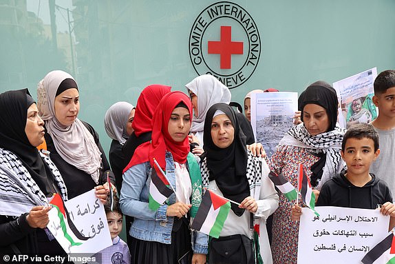 Palestinians gather for a vigil outside the offices of the International Committee of the Red Cross in Beirut on October 11, 2023, in support of the Palestinians in Gaza. The death toll from five days of ferocious fighting between Hamas and Israel rose sharply overnight as Israel kept up its bombardment of Gaza on October 11, after recovering the dead from the last communities near the border where Palestinian militants had been holed up. (Photo by ANWAR AMRO / AFP) (Photo by ANWAR AMRO/AFP via Getty Images)