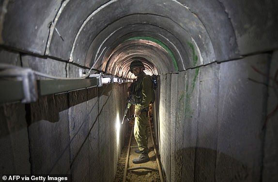 An Israeli army officer walks on July 25, 2014 during an army-organised tour in a tunnel said to be used by Palestinian militants from the Gaza Strip for cross-border attacks. Israel launched its military offensive aiming at destroying tunnels used by Gaza militants. AFP PHOTO / POOL / JACK GUEZ        (Photo credit should read JACK GUEZ/AFP via Getty Images)