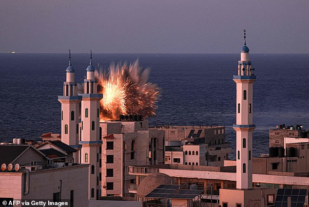 A fireball erupts from an Israeli airstrike in Gaza City on Thursday
