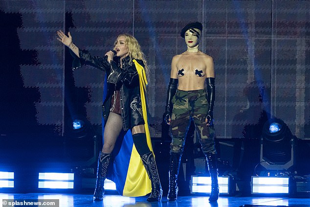 United: The singer strutted around the stage wearing the Ukraine flag as a cape